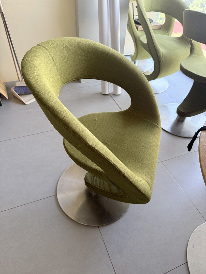 Modern Swivel Accent Chair (Category: Chairs) located in Manila. Submitted by jylesang (Listing ID 1468178980, Image 3). Description: - Style: Modern accent chair with a unique curved wraparound backrest - Material: Clean textured upholstery in an olive/lime green tone - Base: Sturdy chrome circular base that rotates smoothly and stands firm on tiled floors - Comfort: Plush cushioned seat for everyday use - Best for: Home offices, art studios, or