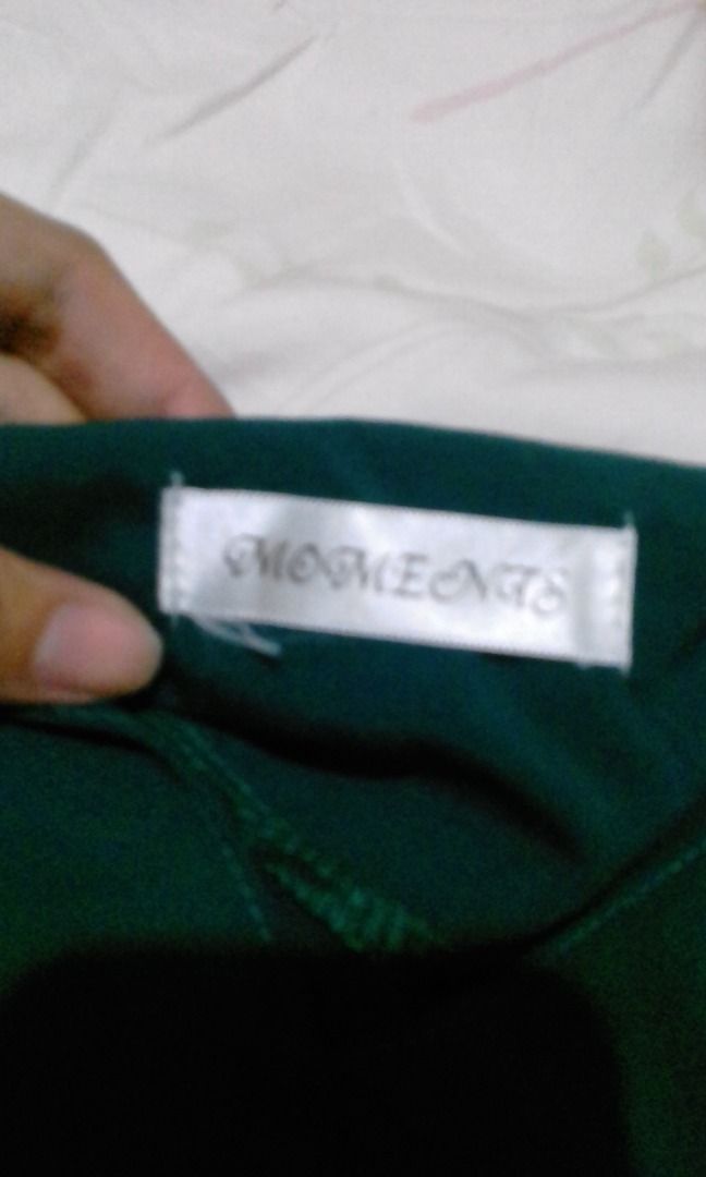 MOMENTS Dark Green Top (Category: Blouses) located in La Trinidad. Submitted by roseee.a84fe6 (Listing ID 1468210560, Image 2). Description: - Brand: Moments - Color: Deep dark green - Material: Smooth and comfortable fabric - Design: Simple, versatile, and easy to pair with any bottoms - Condition: Great basic piece for daily outfits - Details: Official Moments logo tagged inside the collar.