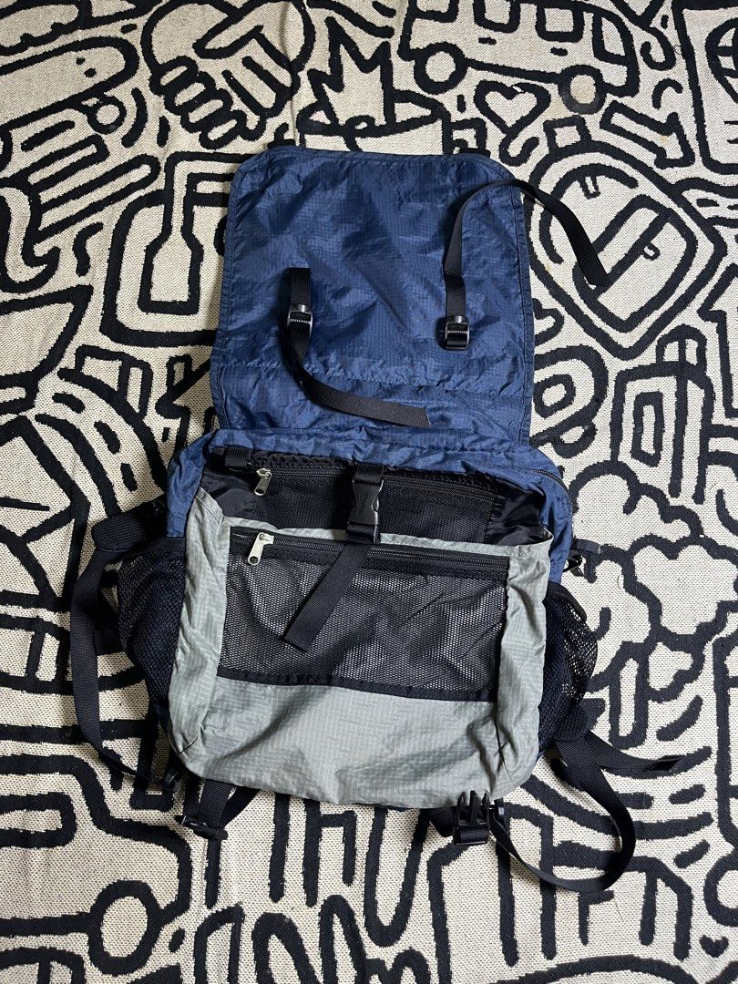 Mont-bell Nylon Backpack Blue Grey Style #1623103 (Category: Backpacks) located in Silang. Submitted by yusthrift (Listing ID 1468175850, Image 3). Description: - Brand: Mont-bell - Style/Model: #1623103 (Made in Vietnam) - Color: Blue and Grey - Material: Durable nylon with black fabric interior lining - Closure: Top flap with buckle - Pockets: Front zippered pocket, mesh side pockets, and spacious main compartment - Features: Top carrying handl