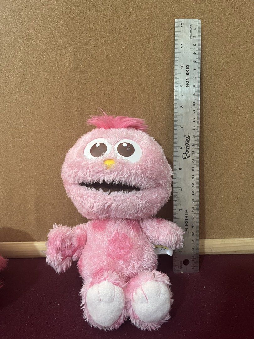 Moppy Sesame Street Plush (Category: Plushies & Soft Toys) located in Baguio. Submitted by gaara1234 (Listing ID 1468073944, Image 1). Description: - Adorable furry pink plush monster toy with darker pink spots - Measures approximately 22 cm tall - Features big brown and white eyes, a bright yellow nose, and tufted pink hair - Soft textured body with clean white feet - Excellent, clean condition and ready for a new home.