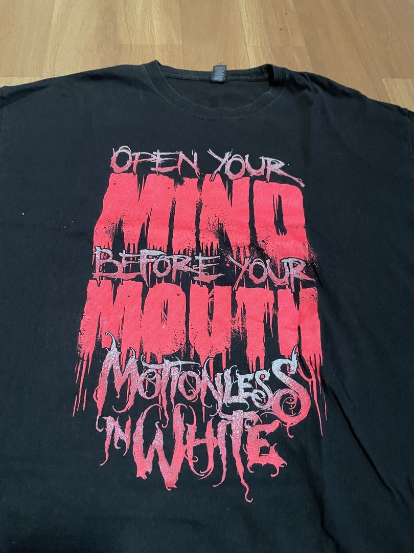 Motionless in White Open Your Mind Band Tee (Category: Tshirts & Polo Shirts ) located in Minalabac. Submitted by heatdosage (Listing ID 1468157466, Image 2). Description: - Band: Motionless in White - Design: 'Open Your Mind Before Your Mouth' large front graphic in red and white - Size: XL (Regular fit, short sleeves) - Material: 100% pre-shrunk cotton - Tag: M&O Gold tag - Condition: Minor fading from washing, no holes or stains 22x30.