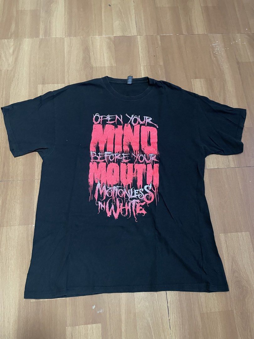 Motionless in White Open Your Mind Band Tee (Category: Tshirts & Polo Shirts ) located in Minalabac. Submitted by heatdosage (Listing ID 1468157466, Image 1). Description: - Band: Motionless in White - Design: 'Open Your Mind Before Your Mouth' large front graphic in red and white - Size: XL (Regular fit, short sleeves) - Material: 100% pre-shrunk cotton - Tag: M&O Gold tag - Condition: Minor fading from washing, no holes or stains 22x30.