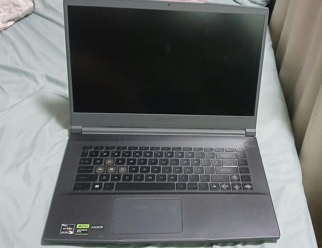 MSI Thin A15 B7uc 655PH Gaming Laptop (Category: Laptops & Notebooks) located in Abucay. Submitted by jerlynbal98316 (Listing ID 1468121145, Image 2). Description: - Brand/Model: MSI Gaming Laptop - Color: Dark grey chassis with stylish cyan accents on WASD and trim - Performance: Runs smoothly for both gaming and everyday tasks - Display: Sharp and bright screen - Condition: Good overall condition, fully working without issues - Inclusions: Orig