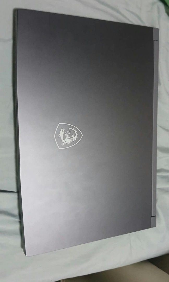 MSI Thin A15 B7uc 655PH Gaming Laptop (Category: Laptops & Notebooks) located in Abucay. Submitted by jerlynbal98316 (Listing ID 1468121145, Image 3). Description: - Brand/Model: MSI Gaming Laptop - Color: Dark grey chassis with stylish cyan accents on WASD and trim - Performance: Runs smoothly for both gaming and everyday tasks - Display: Sharp and bright screen - Condition: Good overall condition, fully working without issues - Inclusions: Orig