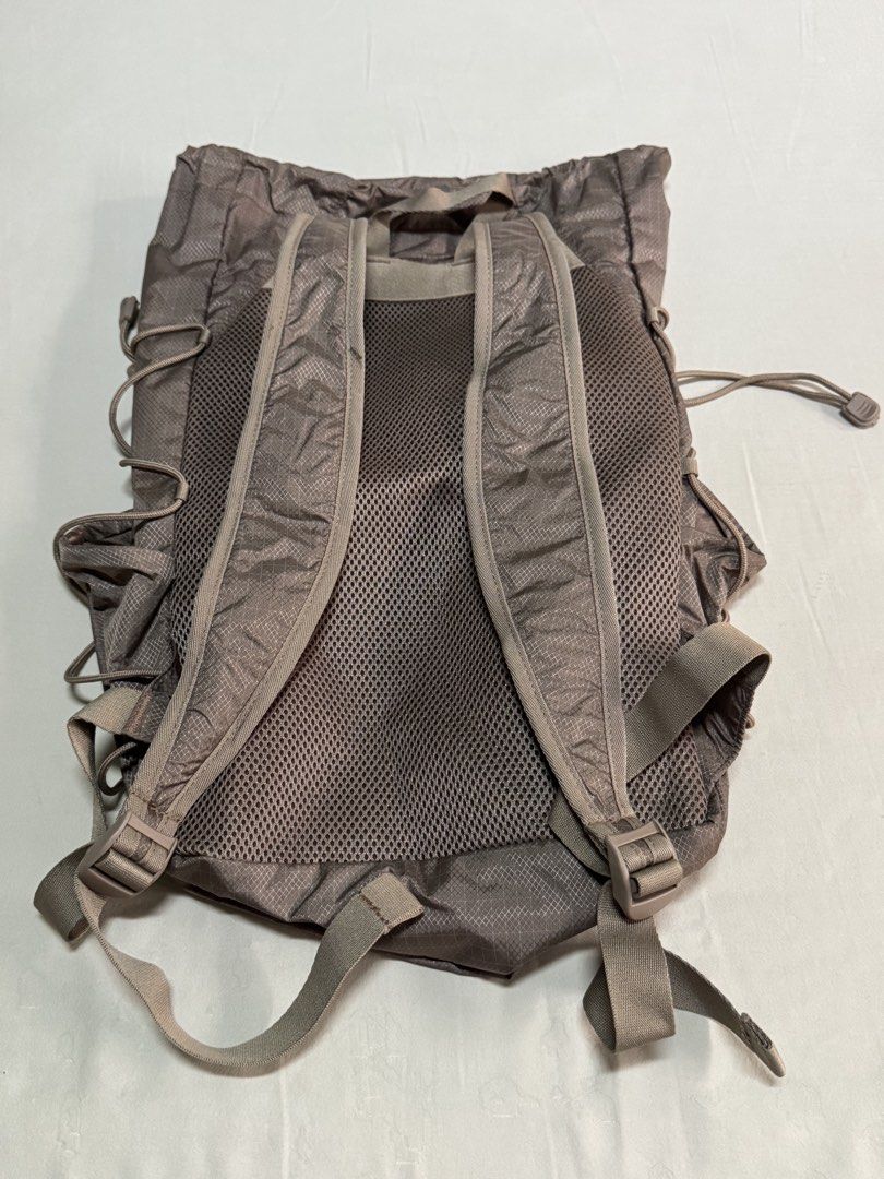 MUJI Nylon Drawstring Backpack Brown (Category: Backpacks) located in Manila. Submitted by zxcvbnmsof (Listing ID 1468214465, Image 2). Description: - Brand: MUJI - Color: Brown with grid pattern - Material: Lightweight nylon - Model: EF0VA6S - Features: Large front mesh pocket with drawstring closure, adjustable mesh-backed shoulder straps, top haul loop, drawstring main compartment, and side cinch cords - Condition: Clean interior and exterior,