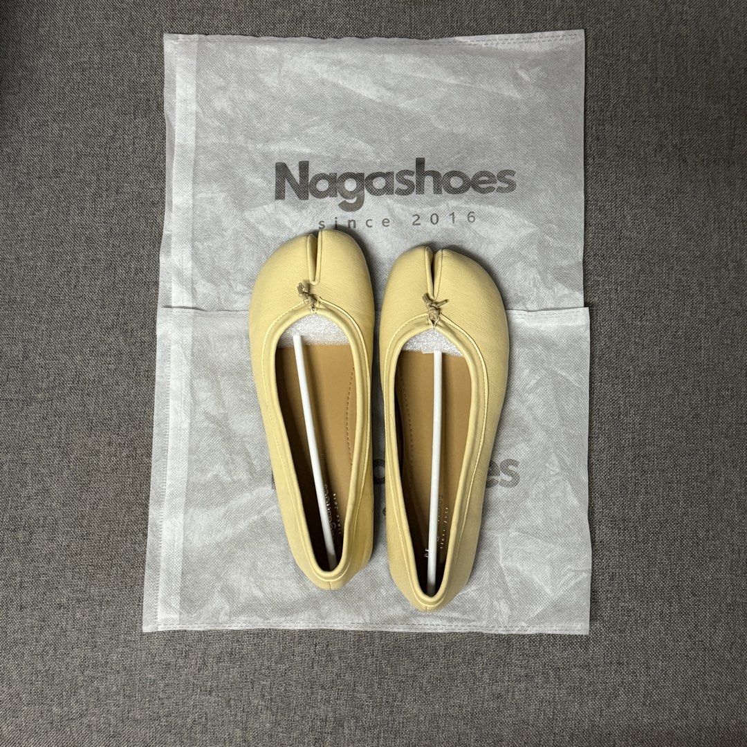 Nagashoes Yellow Split-Toe Tabi Ballet Flats (Category: Flats & Sandals) located in Quezon City. Submitted by claireityyy (Listing ID 1468106739, Image 2). Description: - Brand: Nagashoes - Style: Split-toe tabi ballet flats with front bow detail - Color: Bright yellow with tan inner lining and sole - Condition: Brand new, unworn, and meticulously kept - Inclusions: Original branded dust bag, shape keepers, and toe inserts still inside - Fit/Size