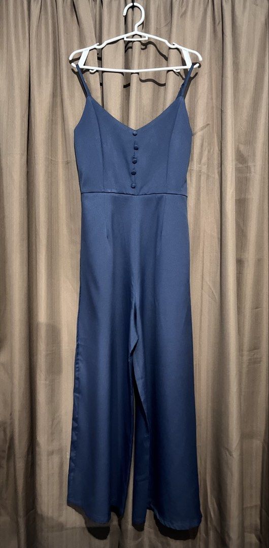 Navy Blue Spaghetti Strap Jumpsuit with Buttons (Category: Jumpsuits) located in Cainta. Submitted by periwinkle.ph (Listing ID 1468202509, Image 1). Description: - Color: Navy blue - Style: Spaghetti strap jumpsuit with a clean silhouette - Fit: Fitted bodice, defined waistline, and wide-leg design - Details: Front center button row and adjustable thin straps - Occasion: Great basic for casual events and outings - Measurements available upon req