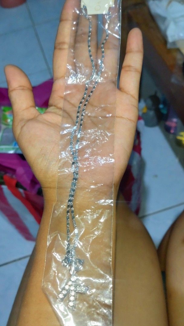 Necklace set (Category: Necklaces) located in Valenzuela. Submitted by diane.35 (Listing ID 1468096805, Image 2). Description: - 2-in-1 necklace bundle for versatile styling - Necklace 1: Faux pearls with gold-tone T-bar closure and rhinestone heart pendant - Necklace 2: Silver-tone chain with sparkle 'K' initial pendant - Condition: Brand new in clear plastic packaging - Great for everyday wear, layering, and gifting.