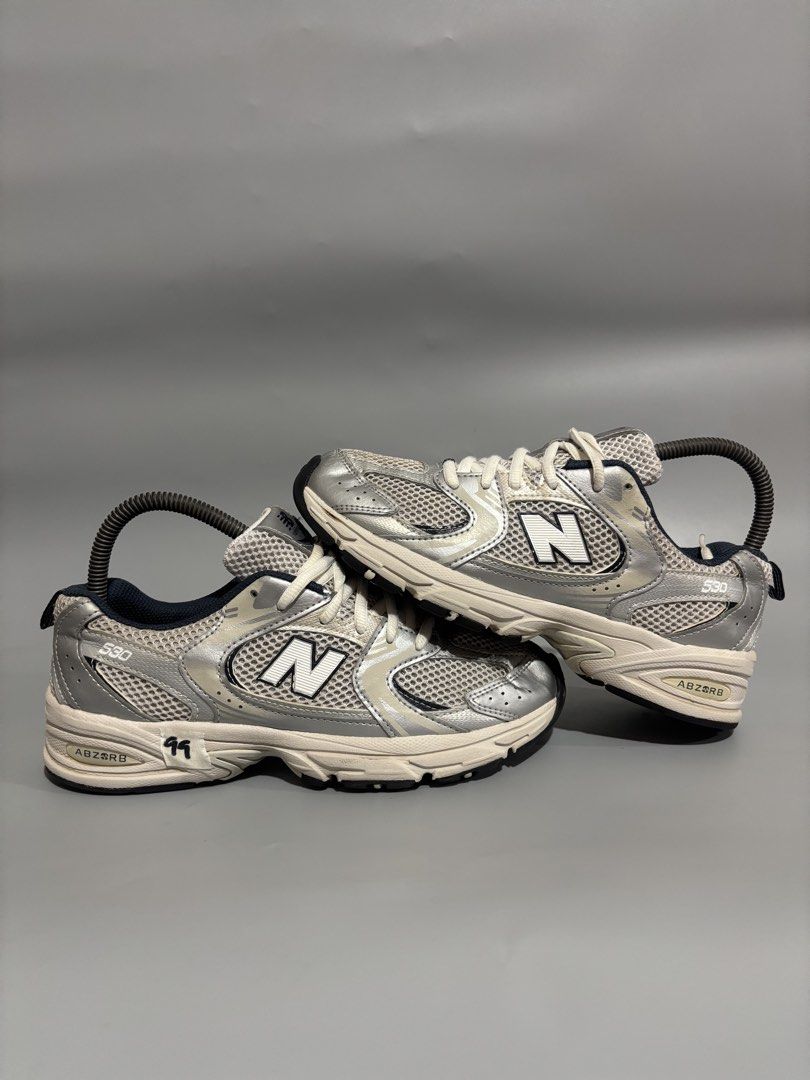 New Balance 530 Silver Metallic Navy (Category: Sneakers) located in Butuan. Submitted by shoeetasho (Listing ID 1468211387, Image 2). Description: - Model: New Balance 530 (Silver/Navy) - Size: US 6.5 Women's / EU 37.5 / 23cm - Condition: Clean outsoles, minimal wear on treads - Features: Mesh upper, metallic overlays, and comfortable ABZORB cushioning - Price: 1,500 PHP with FREE SHIPPING nationwide.