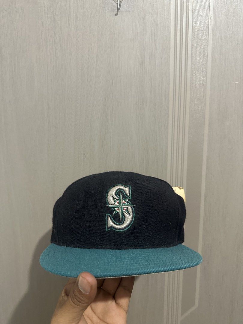 New Era Seattle Mariners 59FIFTY Fitted Cap Size 7 1/2 (Category: Caps & Hats) located in Digos. Submitted by reywearfinds (Listing ID 1468140973, Image 1). Description: - Authentic New Era 59FIFTY Seattle Mariners fitted cap - Size: 7 1/2 - Colorway: Dark crown with a striking teal brim - Condition: Brand new with original retail store tag attached - Authenticity: Includes genuine merchandise and New Era interior woven labels - Origin: Made in U