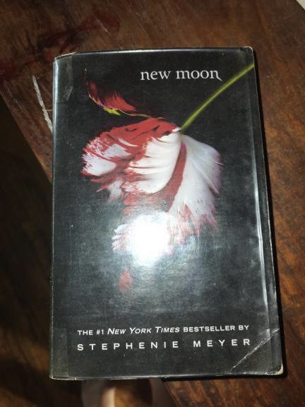 New Moon by Stephenie Meyer (Category: Storybooks) located in Manila. Submitted by geminibibo (Listing ID 1468181813, Image 1). Description: - Title: New Moon by Stephenie Meyer - Series: Twilight (Book 2) - Format: Hardcover with iconic red/white tulip cover art - Condition: Dust jacket shows noticeable wear along edges, corners, and some creasing - Perfect for fans and collectors completing their Twilight set.