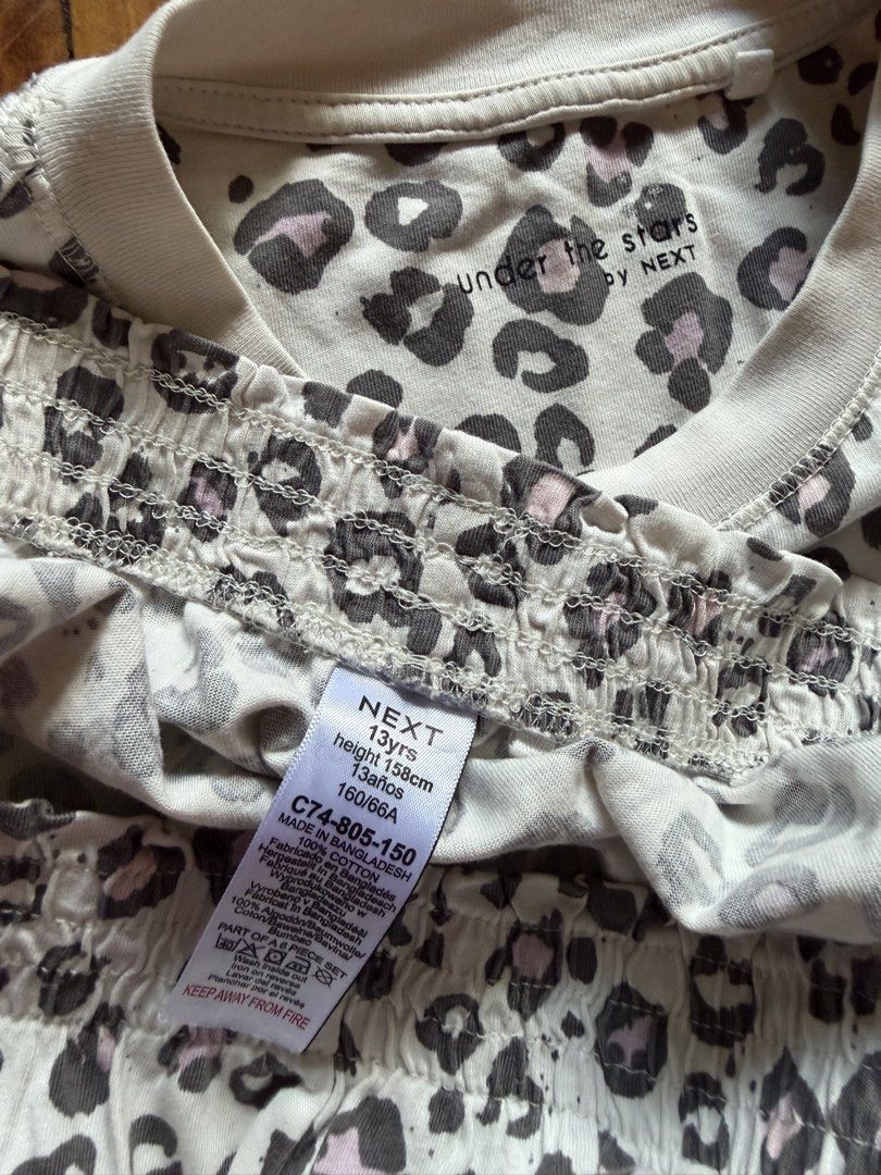 Next Under The Stars Leopard Print Set Size 13Yrs (Category: Babies & Kids Fashion) located in La Trinidad. Submitted by rare_closet_finds (Listing ID 1468279675, Image 2). Description: - Brand: Next (Under the Stars Collection) - Design: Leopard print spots in grey and light pink on a white background - Set includes: Short sleeve top and matching elasticated waist shorts - Material: 100% breathable cotton - Size: Fits height 158cm or age 13 year