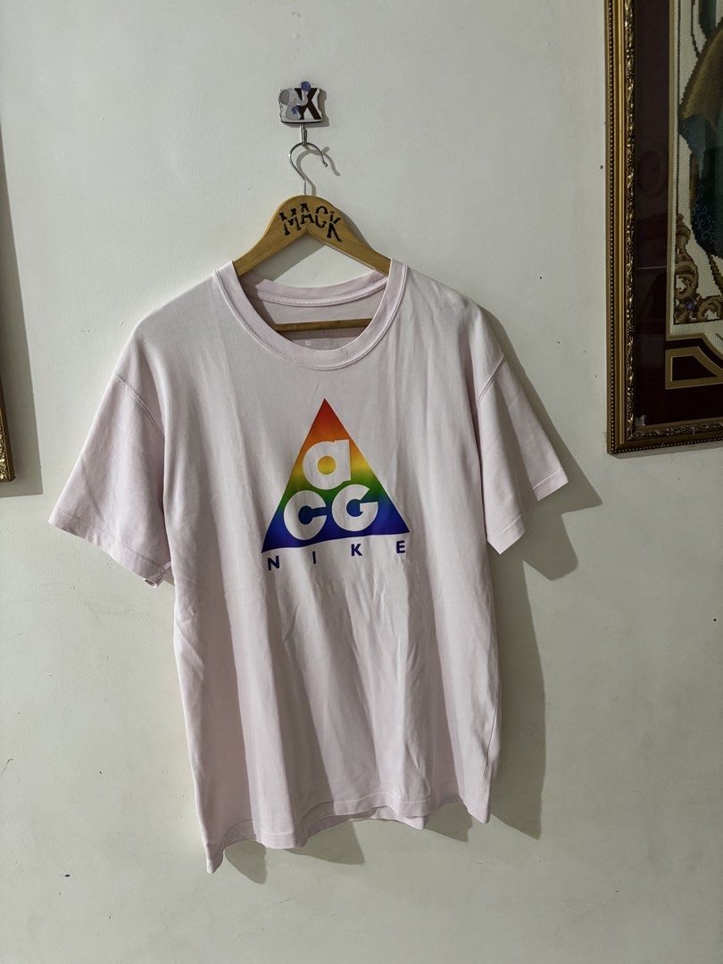 Nike ACG Rainbow Triangle Logo Pink Tee Size L (Category: Tshirts & Polo Shirts ) located in Kalibo. Submitted by mack29 (Listing ID 1468210023, Image 1). Description: - excellent - Color: Light Pink - Size: Large - Design: Large rainbow triangle logo on front, small rainbow tag and swoosh on back collar - Fit: Regular fit crewneck - Style: Casual streetwear - Condition: Good pre-owned condition - Mode of Payment: GCash Excellent .