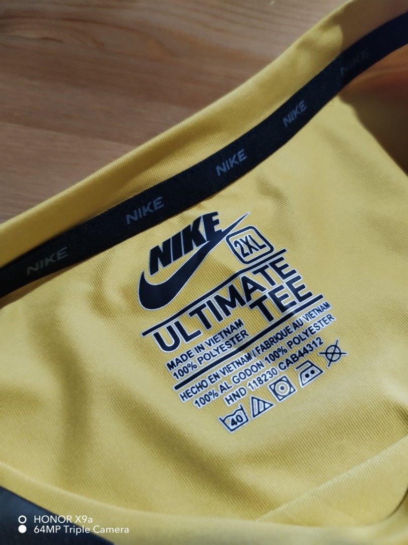 Nike Active Wear (Category: Activewear) located in Muntinlupa City. Submitted by arciagamaryann68 (Listing ID 1468102313, Image 3). Description: - Brand: Nike (Ultimate Tee / Active Wear) - Color: Mustard Yellow with subtle pattern and Nike logo design - Size: 2XL (Tagged 3XL on hang tag) - Material: 100% Polyester with Nike Dri-Fit technology for quick sweat evaporation - Condition: Brand new with tags attached - Features: Long sleeves, lightwei