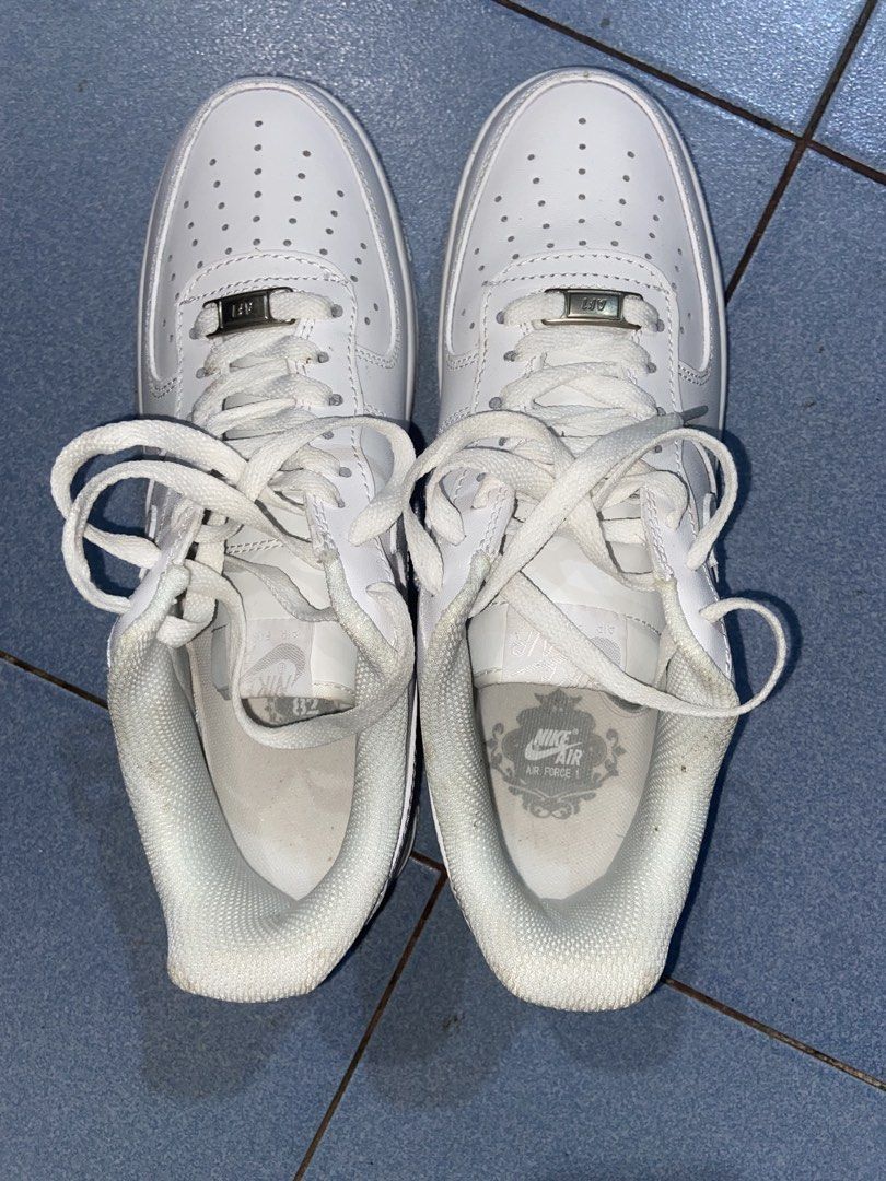 Nike Air Force 1 Low White Triple White (Category: Sneakers) located in Dumaguete. Submitted by riri_selling (Listing ID 1468229902, Image 3). Description: - Brand: Nike - Model: Air Force 1 Low (All-White) - Upper Material: Premium white leather with tonal stitching - Features: Perforated toe box, metal AF1 lace deubré, and chunky rubber sole with Air cushioning - Condition: Regular wear visible on the interior lining and soles - Style: Classic,
