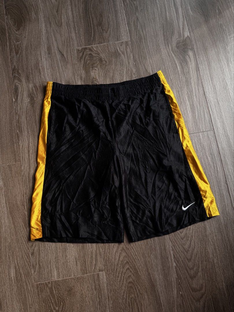 Nike baller short (Category: Shorts) located in Manila. Submitted by isseyboi (Listing ID 1468077741, Image 1). Description: - Brand: Nike - Style: Vintage basketball shorts - Color: Black with gold side stripes - Logo: Embroidered white Swoosh - Size: Medium (M) - Material: 100% polyester body and lining - Origin: Made in Thailand - Features: Elastic waistband with interior Nike Basketball branding tag, lightweight, breathable mesh texture.