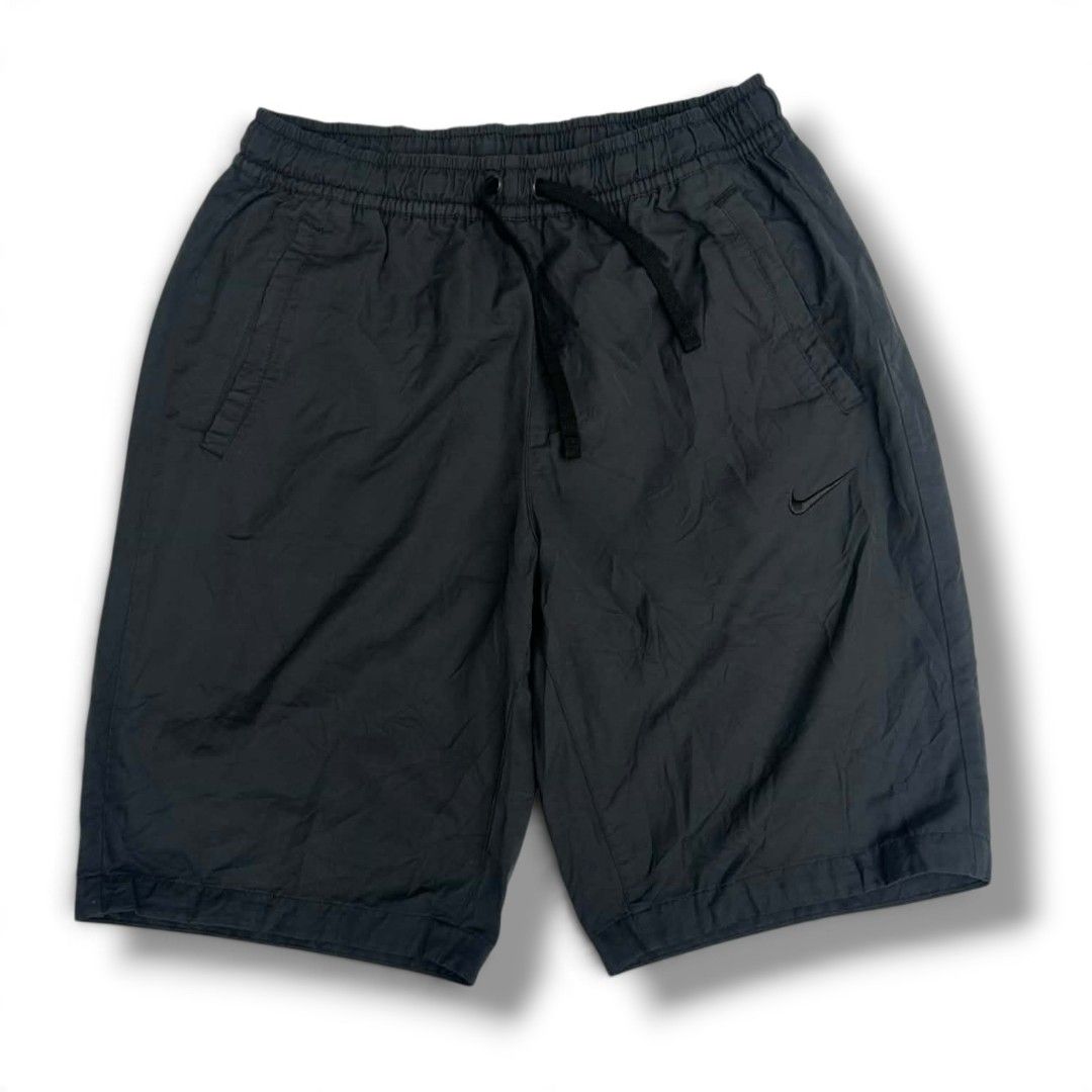 Nike Black Nylon Shorts with Drawstring (Category: Shorts) located in Pantukan. Submitted by modhexx (Listing ID 1468080982, Image 1). Description: - Brand: Nike - Colors available: Dark grey or black - Material: Lightweight nylon with a subtle crinkle texture - Fit: Relaxed fit through the thighs - Waistband: Elastic with matching black drawstring - Pockets: Two front side pockets - Branding: Small embroidered black Nike swoosh logo on the left 