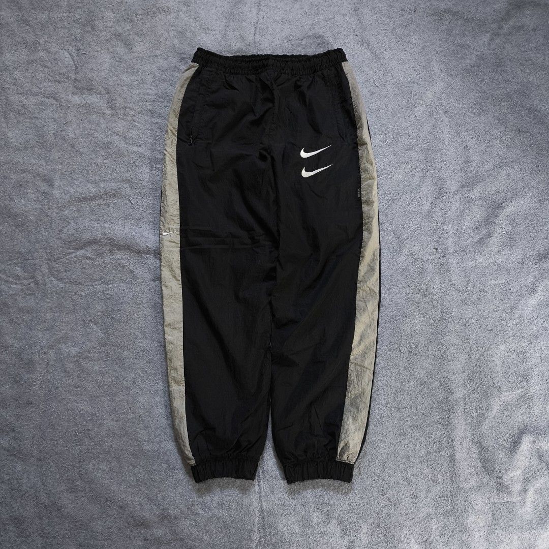 Nike Double Swoosh Nylon Track Pants (Category: Activewear) located in Manila. Submitted by shykes_26 (Listing ID 1468113618, Image 1). Description: Dimensions: Waist - 30-40 (M on tag) Length - 36.5 Thigh - 14 Leg open - 5 Issues: 1 Pinhole (not visible).