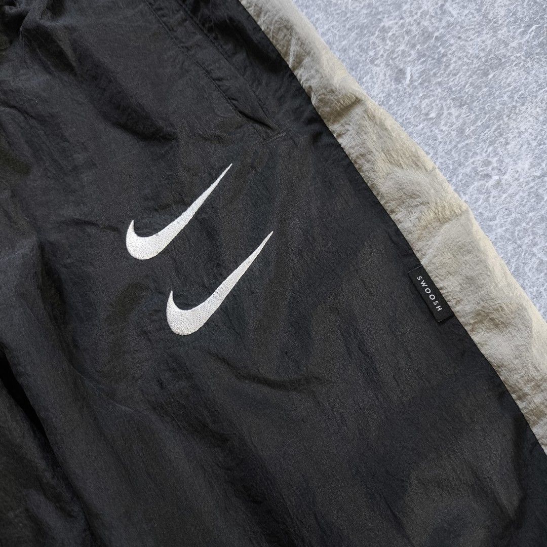 Nike Double Swoosh Nylon Track Pants (Category: Activewear) located in Manila. Submitted by shykes_26 (Listing ID 1468113618, Image 3). Description: Dimensions: Waist - 30-40 (M on tag) Length - 36.5 Thigh - 14 Leg open - 5 Issues: 1 Pinhole (not visible).