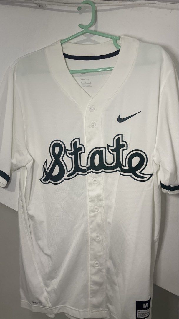 Nike Dri-FIT State Baseball Jersey White Size M (Category: Activewear) located in Cavite. Submitted by tristanmunar (Listing ID 1468168816, Image 1). Description: - Brand: Nike - Color: White with black Swoosh logo - Design: 'State' cursive lettering across the front - Closure: Button-down front - Size: Medium (fit to Large) - Material: Lightweight Dri-FIT performance fabric - Condition/Use: Perfect for game days or casual wear.