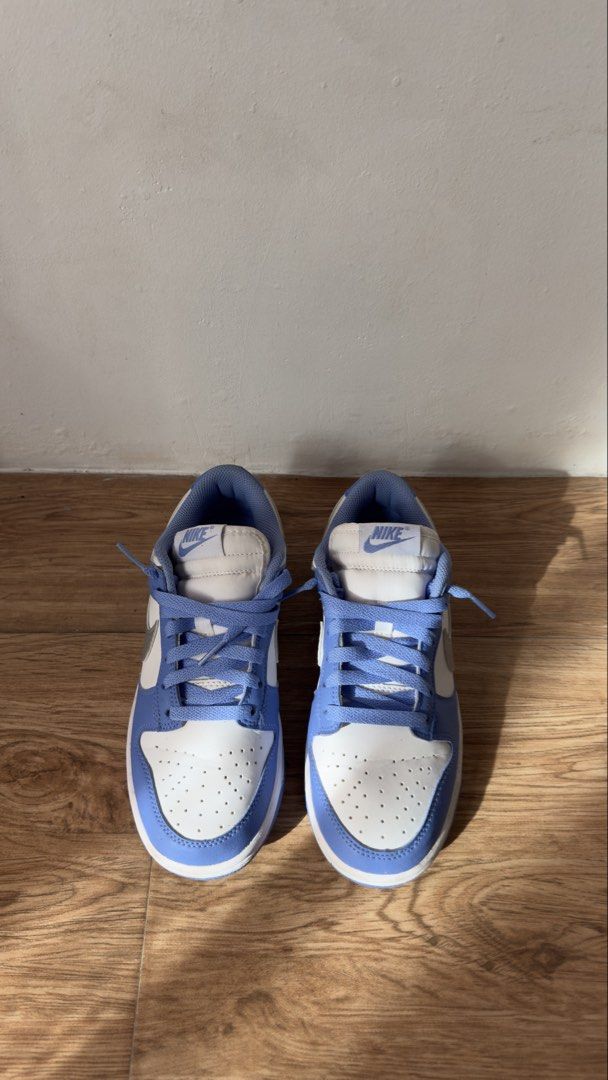 Nike Dunk Low Blue White Sneakers (Category: Sneakers) located in Lipa City. Submitted by eden.cheexe (Listing ID 1468283110, Image 2). Description: Nike Dunk Low sneakers in blue and white colorway. Classic leather upper, perforated toe box, and flat laces. Blue rubber outsole with standard traction pattern. Worn soles show dirt and dust from previous wear. Uppers clean with light creasing on toe boxes. Comfortable everyday skate style kicks..