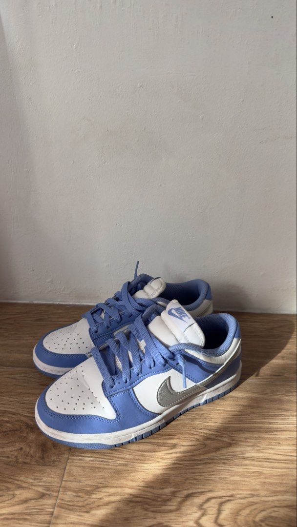 Nike Dunk Low Blue White Sneakers (Category: Sneakers) located in Lipa City. Submitted by eden.cheexe (Listing ID 1468283110, Image 1). Description: Nike Dunk Low sneakers in blue and white colorway. Classic leather upper, perforated toe box, and flat laces. Blue rubber outsole with standard traction pattern. Worn soles show dirt and dust from previous wear. Uppers clean with light creasing on toe boxes. Comfortable everyday skate style kicks..