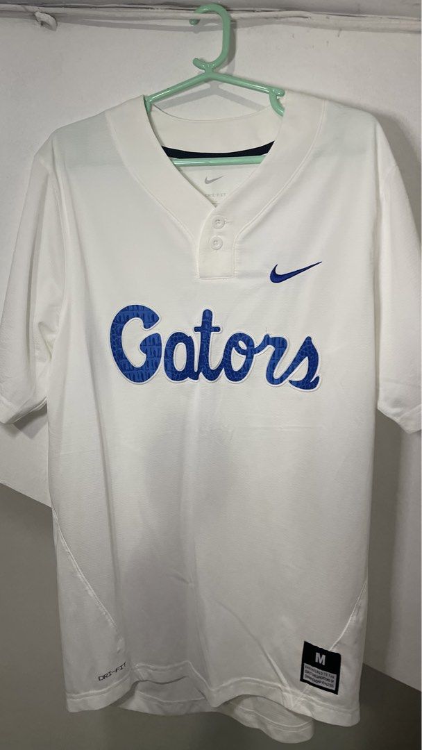 Nike Florida Gators Baseball Jersey White Size M (Category: Activewear) located in Cavite. Submitted by tristanmunar (Listing ID 1468169215, Image 1). Description: - Brand: Nike - Team: Florida Gators - Color: White with blue embroidered script (gator skin pattern inside lettering) - Size: Medium (fit to Large) - Features: Nike swoosh, two-button placket, and Dri-FIT moisture-wicking technology - Condition: Clean, excellent, ready to wear.
