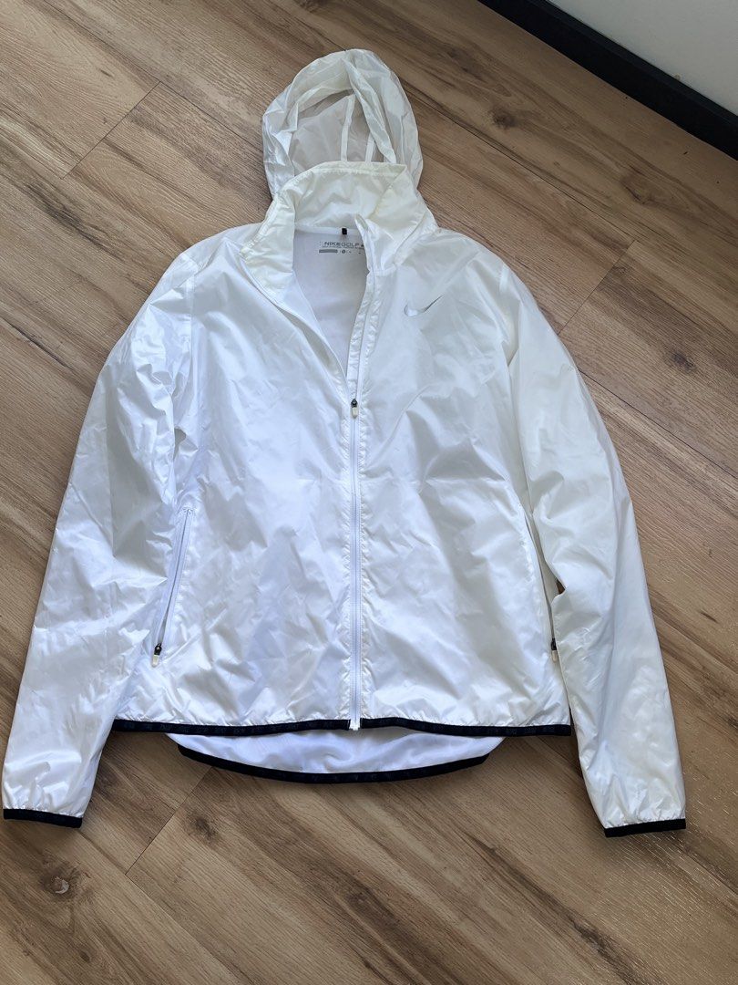 Nike Golf White Hooded Windbreaker Jacket Medium (Category: Coats, Jackets and Outerwear) located in Paranaque City. Submitted by PrelovedClosetetc (Listing ID 1468065401, Image 1). Description: - Brand: Nike Golf - Item: Hooded windbreaker / jacket - Color: White - Features: Full zip front, zippered side pockets, lightweight material - Condition: Good overall with smooth zippers and no rips/tears; has slight yellow discoloration around the insid