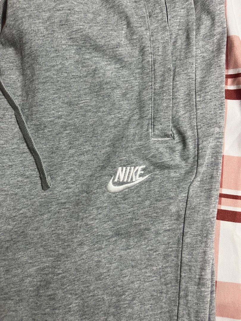 Nike Grey Straight Sweatpants Size S (Category: Joggers) located in Pasay City. Submitted by Oboyyy (Listing ID 1468090567, Image 2). Description: - Brand: Nike - Color: Grey - Size: Small - Material: Comfortable cotton blend - Fit: Elastic waistband with adjustable drawstring and ribbed cuffs - Details: Two side pockets and embroidered white Nike logo on the left thigh - Condition: Excellent, great for lounging or casual wear - Made in: China.