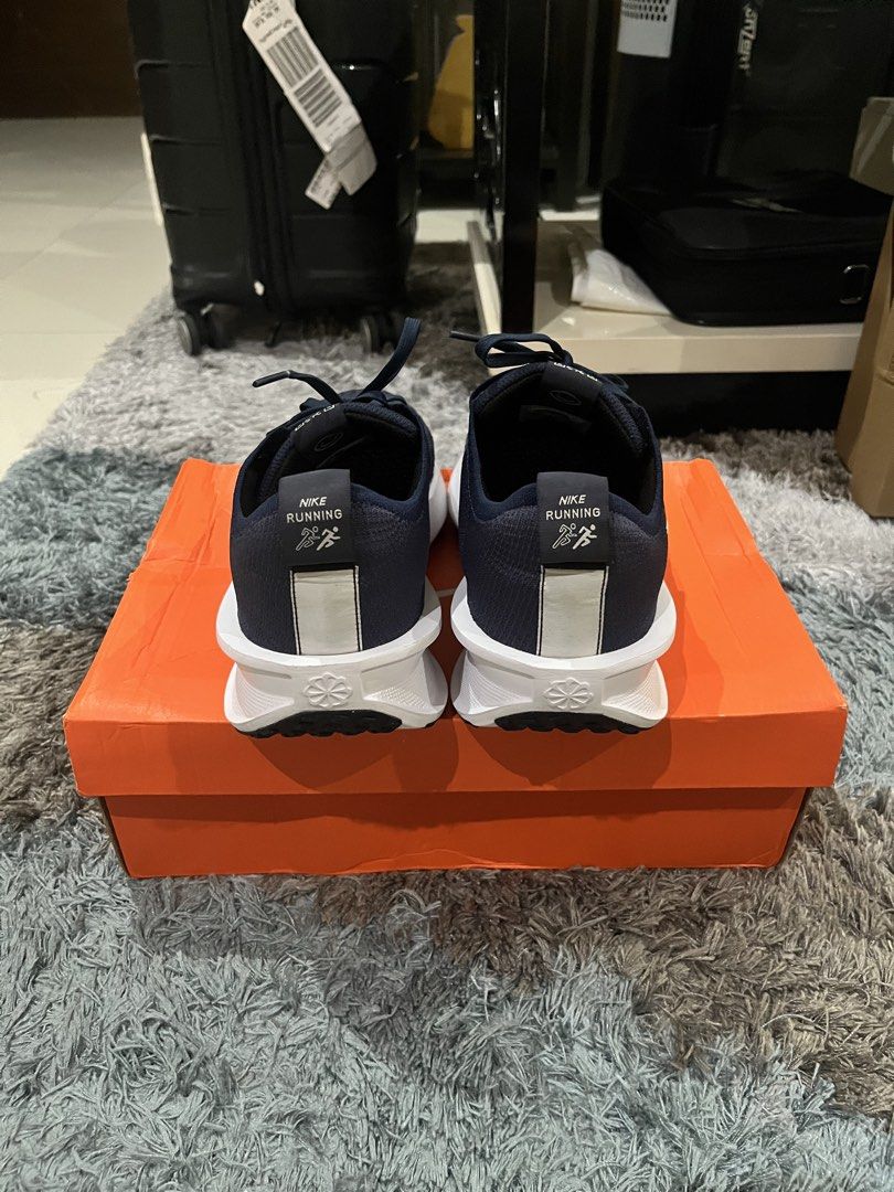 Nike Interact Run College Navy Platinum Tint Size 10 (Category: Sneakers) located in Manila. Submitted by jpnghua_08 (Listing ID 1468094982, Image 3). Description: - Model: Nike Interact Run - Colorway: College Navy / Platinum Tint - Size: Men's US 10 / Women's US 11.5 - Design: Dark blue knitted upper with white embroidered Swoosh and chunky white midsole - Inclusions: Original orange Nike shoebox included.