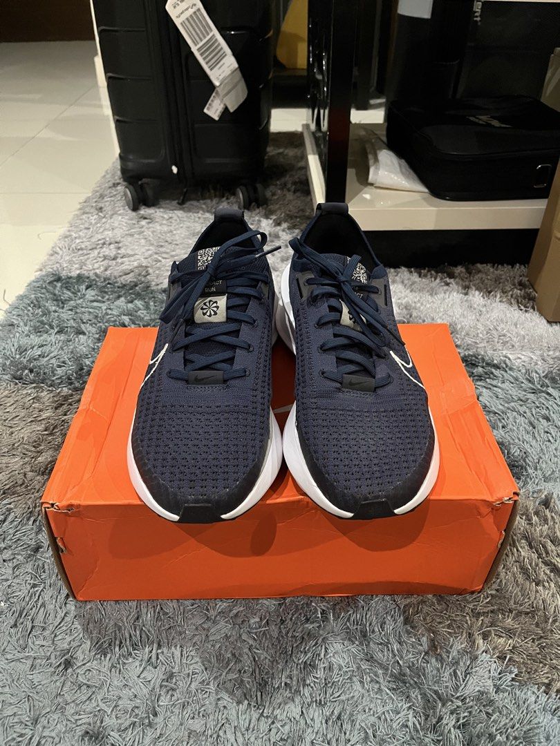 Nike Interact Run College Navy Platinum Tint Size 10 (Category: Sneakers) located in Manila. Submitted by jpnghua_08 (Listing ID 1468094982, Image 2). Description: - Model: Nike Interact Run - Colorway: College Navy / Platinum Tint - Size: Men's US 10 / Women's US 11.5 - Design: Dark blue knitted upper with white embroidered Swoosh and chunky white midsole - Inclusions: Original orange Nike shoebox included.