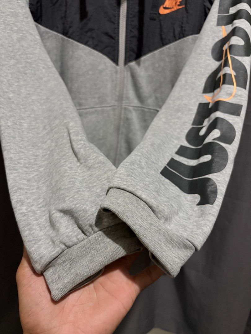 Nike Just Do It Full Zip Hoodie (Category: Hoodies) located in Santo Tomas. Submitted by miguelhussle (Listing ID 1468059646, Image 3). Description: - Brand: Nike -26 L x 23 W - Style: Full zip hoodie with drawstring - Color: Grey and black with contrasting nylon upper chest panel - Features: Front kangaroo pockets, ribbed cuffs and hem - Size: Large - Condition: Excellent - Made in: China.