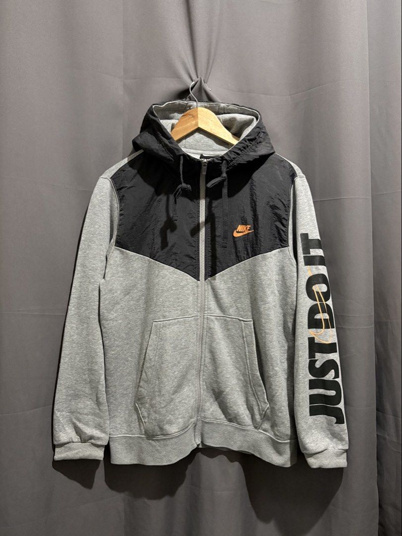 Nike Just Do It Full Zip Hoodie (Category: Hoodies) located in Santo Tomas. Submitted by miguelhussle (Listing ID 1468059646, Image 1). Description: - Brand: Nike -26 L x 23 W - Style: Full zip hoodie with drawstring - Color: Grey and black with contrasting nylon upper chest panel - Features: Front kangaroo pockets, ribbed cuffs and hem - Size: Large - Condition: Excellent - Made in: China.