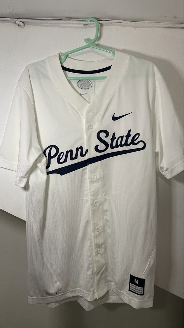 Nike Penn State Baseball Jersey White Size M (Category: Activewear) located in Cavite. Submitted by tristanmunar (Listing ID 1468169636, Image 1). Description: - Brand: Nike - Team: Penn State - Color: White with dark navy blue script lettering - Size: Medium (fit to Large) - Features: Button-down front, Nike Swoosh logo, and moisture-wicking Dri-FIT technology - Condition: Clean, perfect for game days or casual wear.