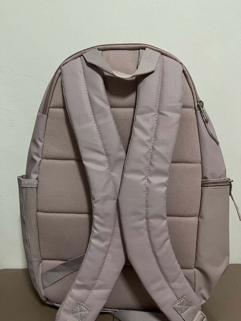 Nike Pink Heritage Backpack Waterproof 20L (Category: Backpacks) located in Caloocan City. Submitted by savastrid (Listing ID 1468119874, Image 3). Description: - Brand: Nike - Capacity: 20 Liters - Color: Dusty Pink (Brand new with hang tags still attached) - Storage: Front zippered pocket with pull tab and convenient side pockets - Comfort: Padded shoulder straps and back panel.