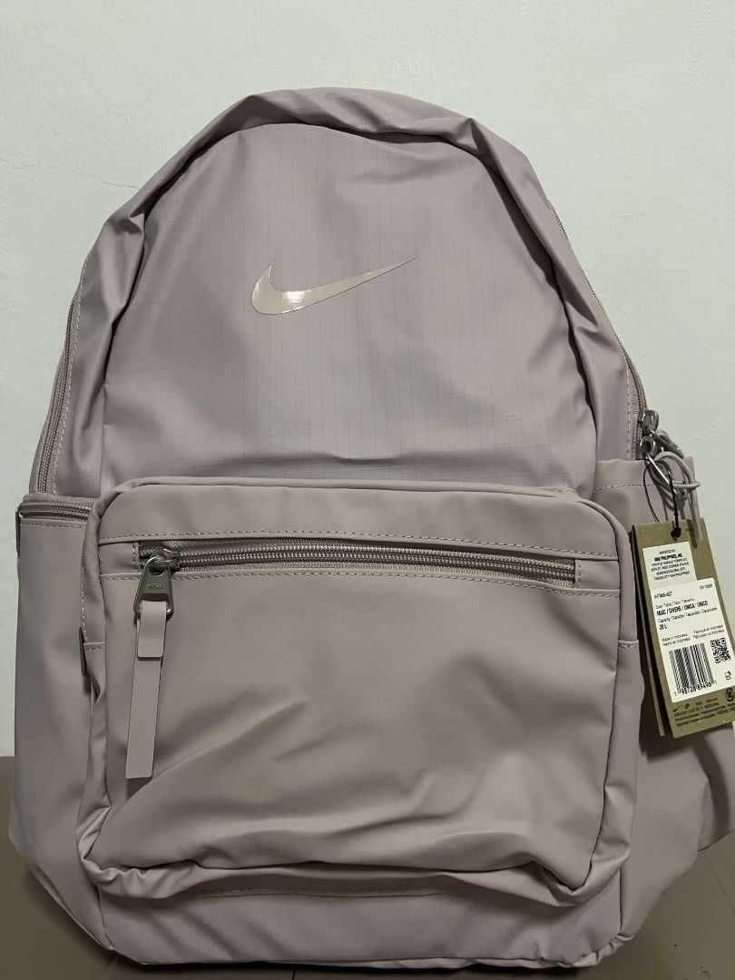 Nike Pink Heritage Backpack Waterproof 20L (Category: Backpacks) located in Caloocan City. Submitted by savastrid (Listing ID 1468119874, Image 1). Description: - Brand: Nike - Capacity: 20 Liters - Color: Dusty Pink (Brand new with hang tags still attached) - Storage: Front zippered pocket with pull tab and convenient side pockets - Comfort: Padded shoulder straps and back panel.