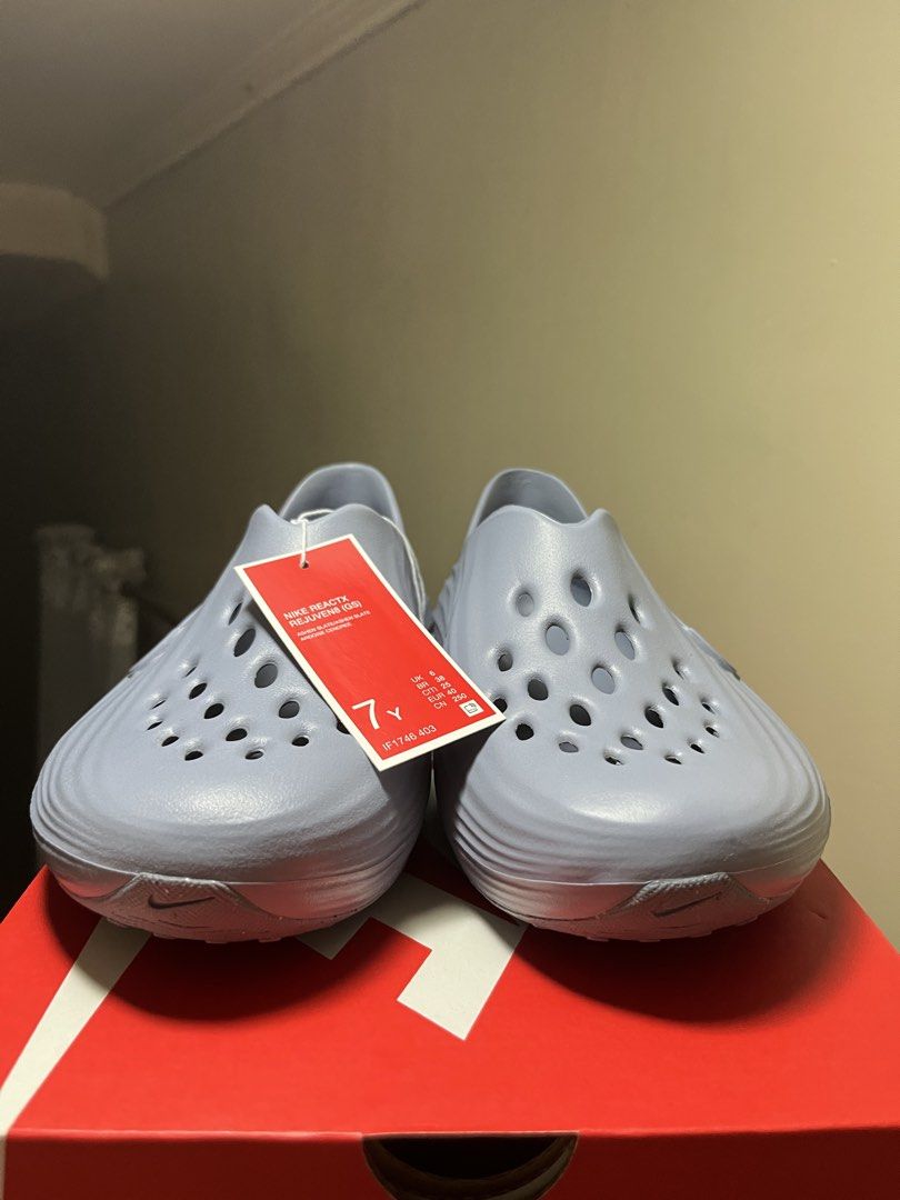Nike ReactX Rejuven8 GS Ashen Slate (Category: Sneakers) located in Valenzuela. Submitted by rr.sneakerstash (Listing ID 1468192806, Image 3). Description: - Brand: Nike - Model: ReactX Rejuven8 - Colorway: Ashen Slate - Size: Youth 7Y - Condition: Brand new, unworn, straight out of the box - Design: Slip-on recovery shoe with all-over ventilation holes and side swoosh branding - Midsole: Stylish ribbed wave texture for extra comfort - Inclusions