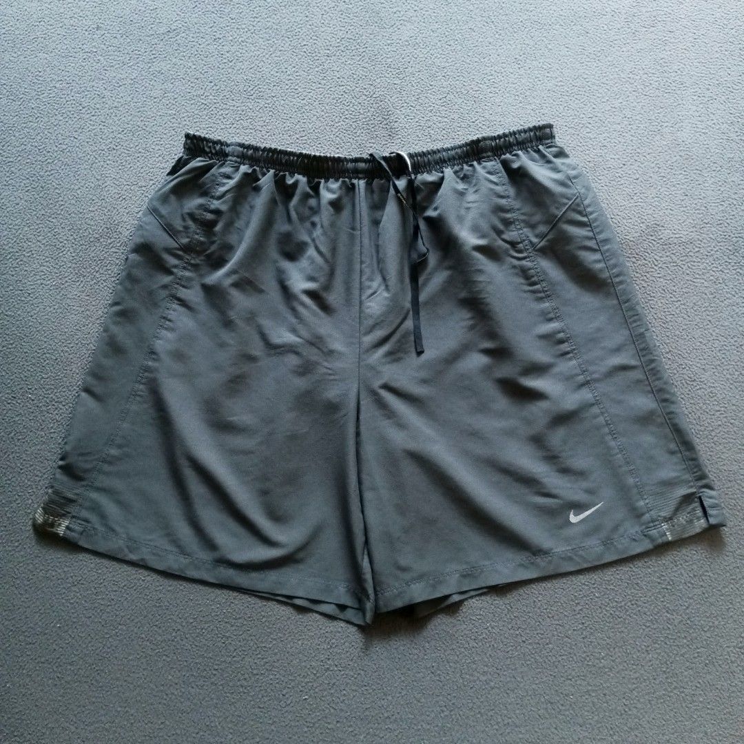 Nike Running Shorts Grey Drawstring (Category: Shorts) located in Manila. Submitted by eyldrn (Listing ID 1468097827, Image 1). Description: - Brand: Nike - Color: Dark Grey - Material: Lightweight with paneled construction - Features: Elastic waistband with branded drawstring, small reflective swoosh logo on lower leg - Condition: Inside care tags intact - Best for: Workouts, runs, or casual wear Nike shorts , pang jogging nyo mga boss Size W-Fr