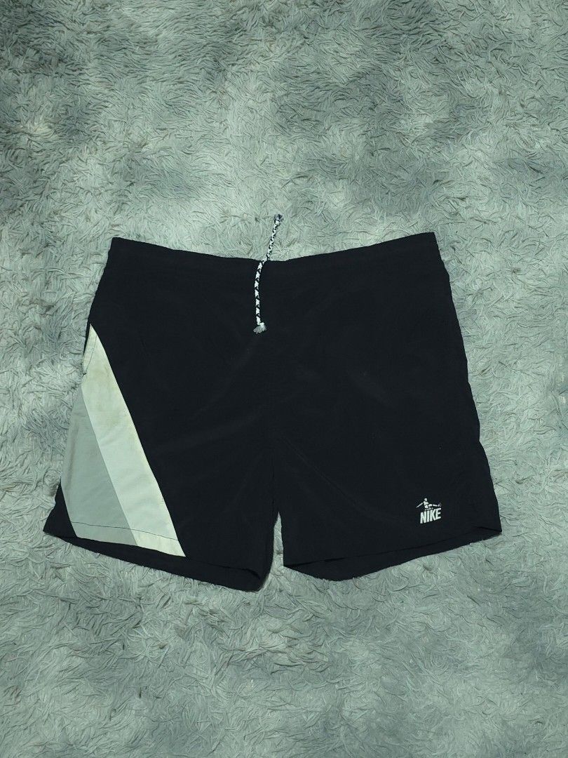 Nike Sportswear Black Shorts (Category: Shorts) located in Abulug. Submitted by humanwhosellthings (Listing ID 1468184320, Image 1). Description: - Brand: Nike Sportswear ✅Excellent Condition ✅Issue: none ▫️Waist Size: 36-40 ▫️Length: 17 - Color: Black with white, green, and grey colorblock panel - Details: White Nike logo near hem, elastic waistband with patterned drawstring - Pockets: Includes a back pocket with button closure and striped tab.