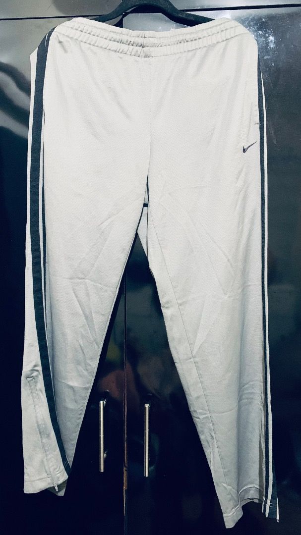 Nike Sweat Pants (Dark Grey) (Category: Joggers) located in Taguig. Submitted by reused.unused (Listing ID 1468199303, Image 1). Description: Nike Sweat Pants (Dark Grey) Embroidered Swoosh (Black) L on tag 40in width (waist) 43in length (waist to hem) 9.5in width (zippered leg opening) Issue/s: signs of usage -refer to photos for actual condition -refer to close up photo for actual color -pre-loved item so signs of usage is expected -for serious