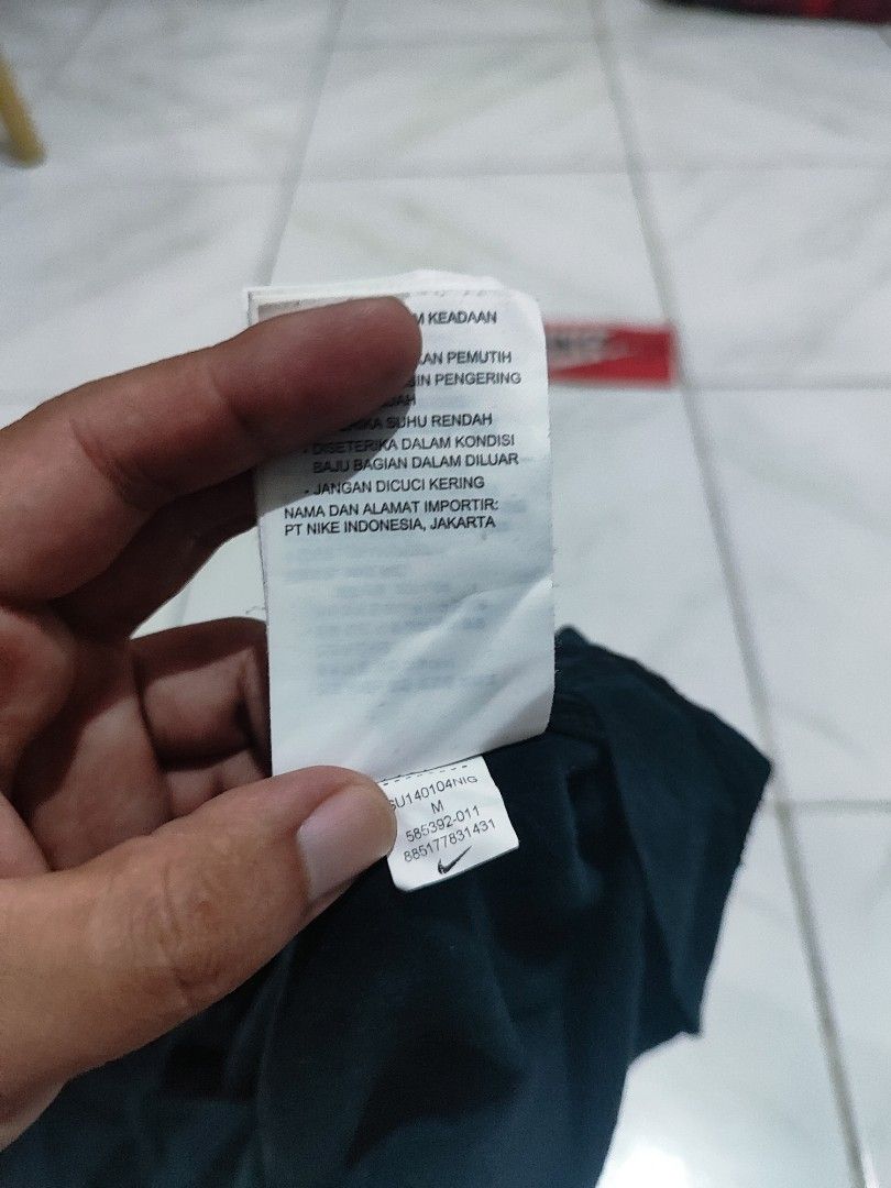Nike tank top or sando (Category: Tshirts & Polo Shirts ) located in Tuguegarao City. Submitted by johnpetera0818 (Listing ID 1468252608, Image 3). Description: - Brand: Nike - Style: Sleeveless tank top with contrasting white ribbed collar and arm trims - Color: Dark navy / black with white printed logo on chest - Size: Medium (refer to tag) - Measurements: Approx. 19 inches across (pit-to-pit) by 28 inches down - Condition: Made in China, inclu