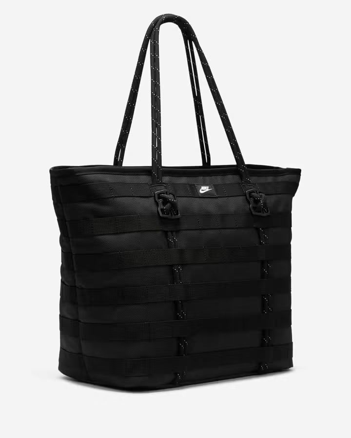 Nike Utility Tote Bag Black (Category: Tote Bags) located in Caloocan City. Submitted by savastrid (Listing ID 1468119411, Image 1). Description: - Color: All Black - Material: Heavy-duty and durable construction - Design: Modern look with exterior tactical straps, loops, and a white embroidered Nike swoosh - Straps: Sturdy dual shoulder straps accented with reflective threading - Storage: Spacious interior ideal for daily essentials, gym clothes