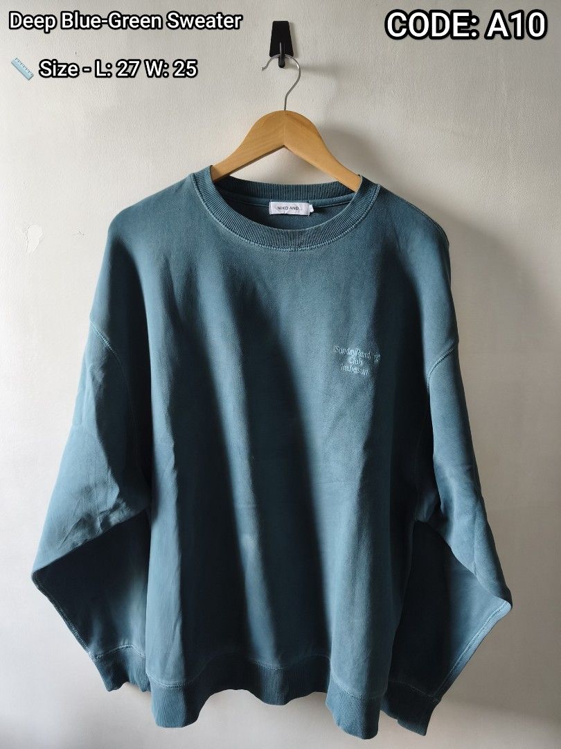 Niko And.. Deep Blue-Green Sweater Code A10 (Category: Longsleeves) located in Manila. Submitted by gelog2 (Listing ID 1468145592, Image 1). Description: - Brand: Niko And... - Color: Deep blue-green - Design: Small embroidered 'Sunday Reading Club' text on chest - Fit: Relaxed fit with dropped shoulders - Details: Ribbed collar, cuffs, and hem - Measurements: Length 27", Width 25".