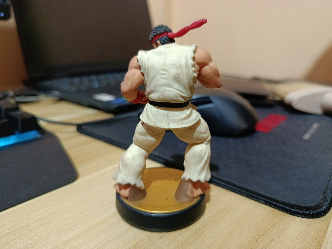 Nintendo Ryu Amiibo Super Smash Bros Figure (Category: Figurines & Statues) located in Ligao. Submitted by travis40 (Listing ID 1468242166, Image 3). Description: - Character: Ryu (Super Smash Bros / Street Fighter) - Edition: Gold base edition Amiibo figure - Design: Highly detailed sculpting in his classic martial arts gi and red headband - Authenticity: 100% official Nintendo merchandise - Ideal for: Gaming enthusiasts and fighting game figure