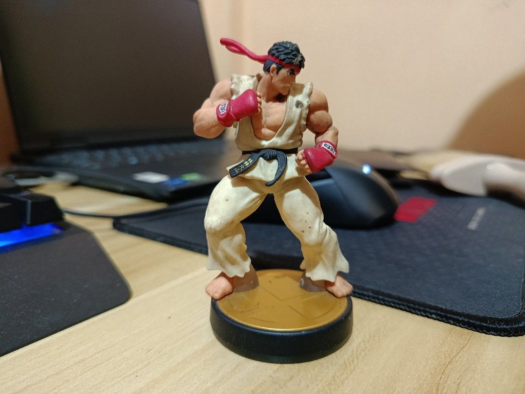 Nintendo Ryu Amiibo Super Smash Bros Figure (Category: Figurines & Statues) located in Ligao. Submitted by travis40 (Listing ID 1468242166, Image 2). Description: - Character: Ryu (Super Smash Bros / Street Fighter) - Edition: Gold base edition Amiibo figure - Design: Highly detailed sculpting in his classic martial arts gi and red headband - Authenticity: 100% official Nintendo merchandise - Ideal for: Gaming enthusiasts and fighting game figure
