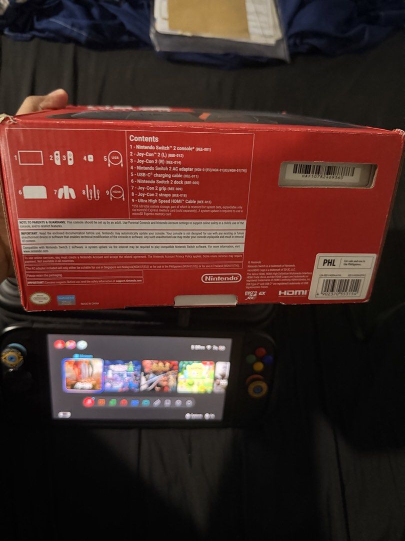 Nintendo Switch 2 Console with Box and Accessories (Category: Nintendo) located in San Pedro. Submitted by kcmabeza (Listing ID 1468089779, Image 3). Description: - Nintendo Switch 2 console and setup bundle - Powers on and displays home screen with games (Pokopia) - Includes original box, dock, and charging cables - Comes with Joy-Con controllers, grip attachment, and custom thumb grips - Packed inside a durable protective carrying case - Adult-