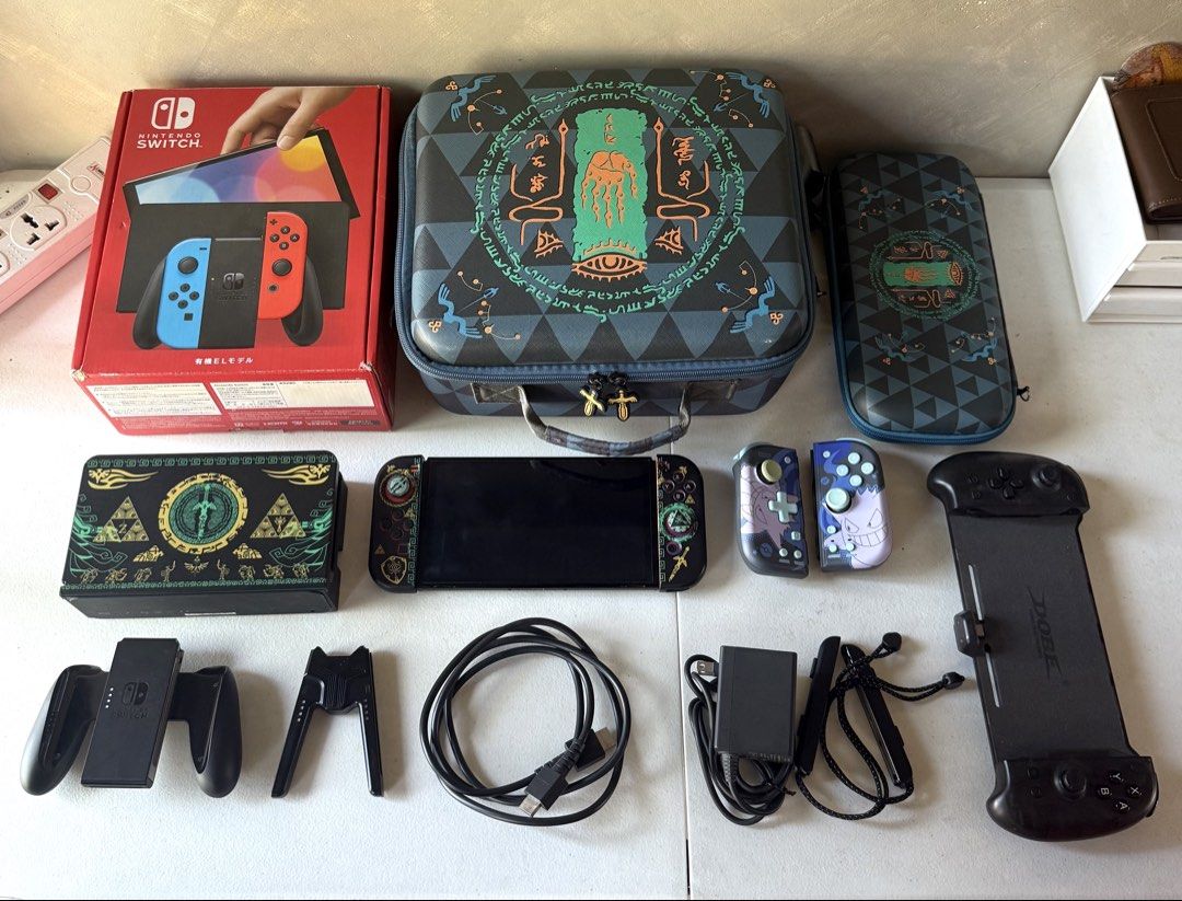 Nintendo Switch OLED (Category: Nintendo) located in Mandaluyong City. Submitted by akebns05 (Listing ID 1468168572, Image 1). Description: 🎮 FOR SALE 🎮 NINTENDO SWITCH OLED BUNDLE + ZELDA-THEMED ACCESSORIES ✨ Inclusions: - Original Box - Unit - Dock - Joycon L & R - Joycon grip - Joycon straps - Original HDMI cable - Original charger Freebies: - 512 GB SD Card - Hori Split Pad (Gengar Edition) - Dobe Controller Grip (With box) - Extra Grip - Z