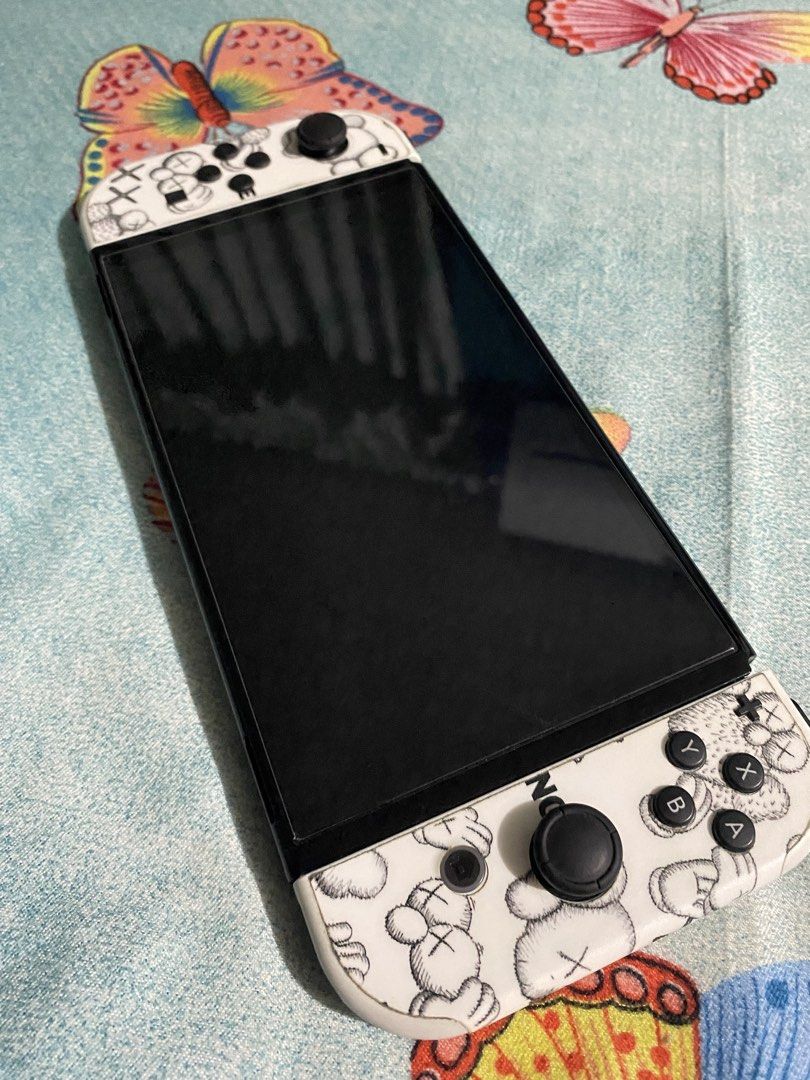 Nintendo Switch OLED (Category: Nintendo) located in General Trias. Submitted by eddd14 (Listing ID 1468245983, Image 3). Description: For Sale Nintendo Switch Oled White Complete Original Accessories with Box 📦 • Nintendo Switch OLED console • Dock • Joy-Con Controllers (L & R) • Joy-Con Grip • Joy-Con Straps • Original Charger • HDMI Inclusions: -128GB SD Card -Mario Carrying Case -NS1 Wireless Controller -2 Pairs Thumb Grip Caps -Tempered Gla