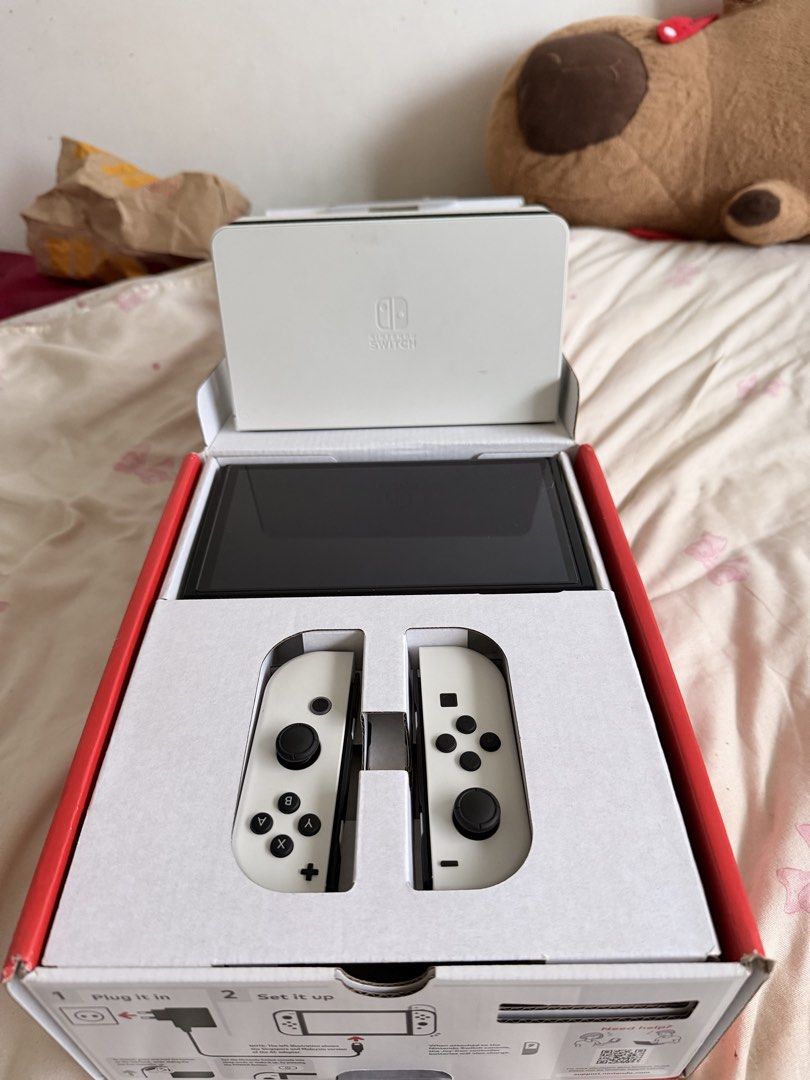 Nintendo Switch OLED Model White WITH Tomodachi Life (Category: Nintendo) located in Quezon City. Submitted by catmumcertiflied (Listing ID 1468144627, Image 2). Description: - Model: Nintendo Switch OLED System (White) - Included: Console, white Joy-Con controllers, white dock, and original box - Display: Vibrant 7-inch OLED screen - Condition: NO ISSUES! like brand new, packs neatly into original packaging - With Tomodachi Life Game - Meetup or