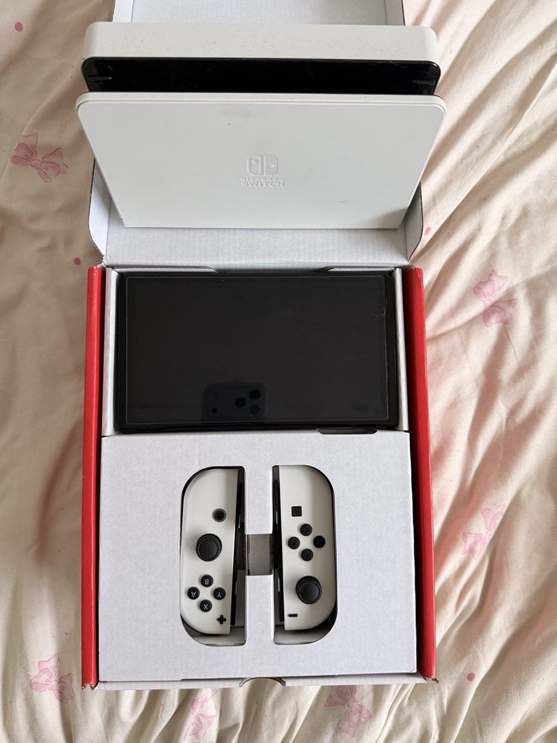 Nintendo Switch OLED Model White WITH Tomodachi Life (Category: Nintendo) located in Quezon City. Submitted by catmumcertiflied (Listing ID 1468144627, Image 1). Description: - Model: Nintendo Switch OLED System (White) - Included: Console, white Joy-Con controllers, white dock, and original box - Display: Vibrant 7-inch OLED screen - Condition: NO ISSUES! like brand new, packs neatly into original packaging - With Tomodachi Life Game - Meetup or